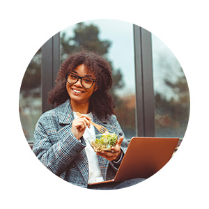 etudiante qui mange salade devant ordinateur